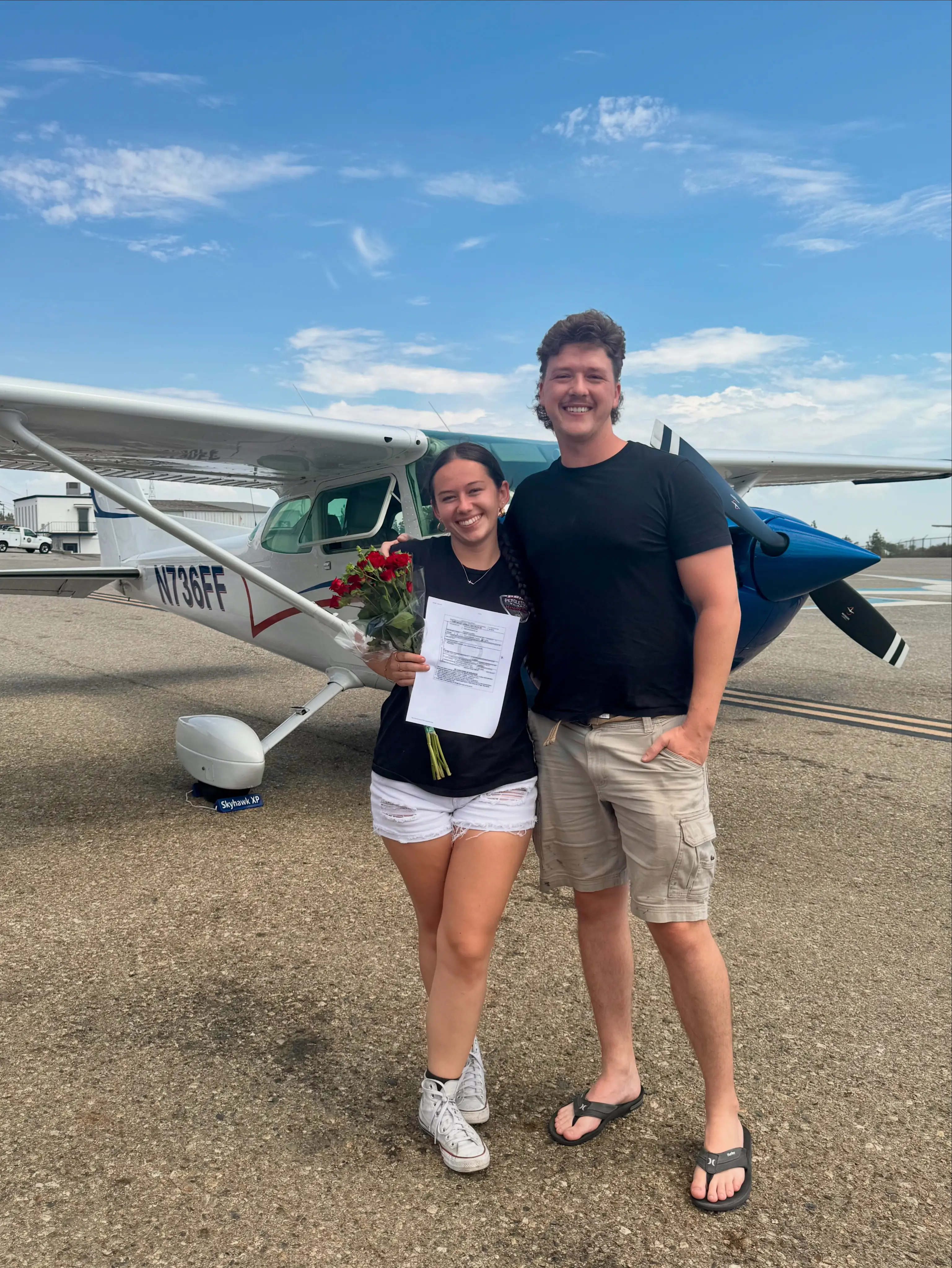Flight instructor celebrating student success after checkride